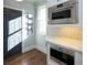 Modern kitchen space featuring stainless steel built-in ovens and a microwave, complemented by sleek countertops and tile backsplash at 4095 Copper Leaf Ln, Cumming, GA 30040