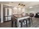 Kitchenette with gray cabinets, stainless steel appliances, brick accent wall and island seating at 4095 Copper Leaf Ln, Cumming, GA 30040