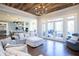 Living room with wood-planked ceiling, recessed lights, french doors leading to deck and open to kitchen area at 4095 Copper Leaf Ln, Cumming, GA 30040