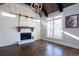 Bright living room with vaulted ceiling, fireplace, wood floors, and large windows offering natural light and views at 4095 Copper Leaf Ln, Cumming, GA 30040