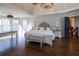 Large main bedroom with hardwood floors features chandelier, natural light from windows, and stylish decor at 4095 Copper Leaf Ln, Cumming, GA 30040