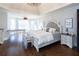 Spacious main bedroom with hardwood floors, sitting area, chandelier, and large windows with ample natural light at 4095 Copper Leaf Ln, Cumming, GA 30040
