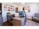 Well-lit home office with a decorative chandelier, colorful rug, and neutral furniture for a comfortable work environment at 4095 Copper Leaf Ln, Cumming, GA 30040