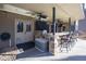 Outdoor bar under covered patio with ceiling fans and television at 4095 Copper Leaf Ln, Cumming, GA 30040