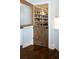 Walk-in pantry offering ample shelving and storage space, featuring a half-door for easy access to food items at 4095 Copper Leaf Ln, Cumming, GA 30040