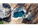 Aerial view of a backyard oasis with a kidney shaped pool, a hot tub and an outdoor kitchen with a built-in grill at 4095 Copper Leaf Ln, Cumming, GA 30040