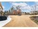 Large backyard featuring a patio, shed, and mature trees at 2600 Reece Farms Sw Trl, Powder Springs, GA 30127