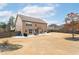 Expansive backyard featuring a patio with outdoor seating and a well-maintained lawn at 2600 Reece Farms Sw Trl, Powder Springs, GA 30127
