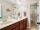 Bright bathroom featuring double vanity, framed mirror, and neutral colored walls at 2600 Reece Farms Sw Trl, Powder Springs, GA 30127