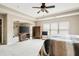 Large bedroom with a ceiling fan, neutral walls, large window, and sitting area at 2600 Reece Farms Sw Trl, Powder Springs, GA 30127