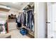 Walk-in closet with rods for hanging clothing and a blue basket at 2600 Reece Farms Sw Trl, Powder Springs, GA 30127