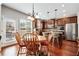 Bright eat-in kitchen area featuring hardwood floors, modern light fixture, and stainless steel appliances at 2600 Reece Farms Sw Trl, Powder Springs, GA 30127