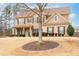 Traditional two-story home featuring a covered front porch and professionally landscaped yard at 2600 Reece Farms Sw Trl, Powder Springs, GA 30127