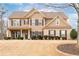 Traditional two-story home with a well-manicured lawn, complemented by shrubs along the front and an inviting entrance at 2600 Reece Farms Sw Trl, Powder Springs, GA 30127