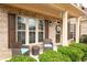 Welcoming front porch with comfortable seating area and decorative accents, framed by lush greenery at 2600 Reece Farms Sw Trl, Powder Springs, GA 30127