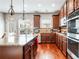 Open gourmet kitchen offers granite countertops, stainless steel appliances, and a view to the backyard patio at 2600 Reece Farms Sw Trl, Powder Springs, GA 30127
