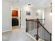 Upstairs hallway with neutral walls, carpet, and railing overlooking a laundry room at 2600 Reece Farms Sw Trl, Powder Springs, GA 30127