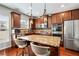 Gourmet kitchen boasts granite countertops, stainless steel appliances, and an island with barstool seating at 2600 Reece Farms Sw Trl, Powder Springs, GA 30127
