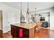 Modern kitchen island with granite countertops, stainless appliances, and view of the living room at 2600 Reece Farms Sw Trl, Powder Springs, GA 30127