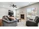 Comfortable living room with a fireplace, large windows, and plush seating at 2600 Reece Farms Sw Trl, Powder Springs, GA 30127