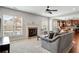 Spacious living room with plush carpeting, a fireplace, and access to the kitchen at 2600 Reece Farms Sw Trl, Powder Springs, GA 30127