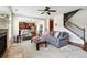 Inviting living room features a cozy fireplace, plush gray carpet, and flows into an eat-in kitchen at 2600 Reece Farms Sw Trl, Powder Springs, GA 30127