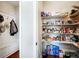 Walk-in pantry with built-in shelving for ample storage plus mud room with bench and storage at 2600 Reece Farms Sw Trl, Powder Springs, GA 30127
