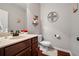 Well-lit powder room featuring a single vanity, wood cabinets, and modern fixtures at 2600 Reece Farms Sw Trl, Powder Springs, GA 30127