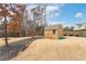 Backyard with a storage shed, landscaped beds, and fenced yard at 2600 Reece Farms Sw Trl, Powder Springs, GA 30127