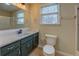 Bathroom with modern fixtures, a vanity with storage, toilet, and walk-in shower at 4131 Carroll Sw St, Covington, GA 30014