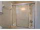 Bathroom features a shower with sliding glass doors and neutral wall color at 4131 Carroll Sw St, Covington, GA 30014