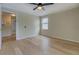 Bedroom features hardwood floors, ceiling fan, paneled walls and a view of the hallway at 4131 Carroll Sw St, Covington, GA 30014