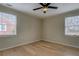 Bedroom offers hardwood floors, a ceiling fan and two windows for natural light at 4131 Carroll Sw St, Covington, GA 30014