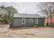 Side exterior view of home with driveway, siding, and metal roof at 4131 Carroll Sw St, Covington, GA 30014