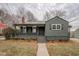 Charming single-Gathering home featuring a covered porch, dark green siding, and a well-maintained landscaped front yard at 4131 Carroll Sw St, Covington, GA 30014