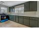 Well-lit kitchen features dark green cabinets, new countertops, stainless steel appliances, and hardwood floors at 4131 Carroll Sw St, Covington, GA 30014