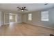 Spacious living room boasts hardwood floors, a modern ceiling fan, and glass doors to another room at 4131 Carroll Sw St, Covington, GA 30014