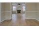 View from one room, looking into the living room with a fireplace, and a ceiling fan at 4131 Carroll Sw St, Covington, GA 30014