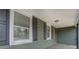 Front porch with two windows with black shutters and green siding at 4131 Carroll Sw St, Covington, GA 30014