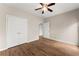 Bedroom with wood-look laminate flooring, ceiling fan, double door closet, and neutral paint at 420 Copeland St, Grayson, GA 30017