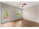 Light bedroom features laminate flooring, neutral colored walls, and a door leading to the deck at 420 Copeland St, Grayson, GA 30017
