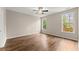 Large bedroom with wood-look floors, two windows providing natural light, and neutral colored walls at 420 Copeland St, Grayson, GA 30017