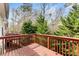 Red wood deck surrounded by green trees and vegetation at 420 Copeland St, Grayson, GA 30017