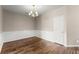 Dining room featuring wood-look flooring, elegant chandelier, and neutral paint at 420 Copeland St, Grayson, GA 30017
