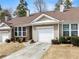 Charming single-story home featuring a one-car garage, manicured shrubs, and an inviting front entrance at 420 Copeland St, Grayson, GA 30017