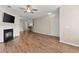 Open-concept living area with fireplace, ceiling fan, and seamless flow to the kitchen at 420 Copeland St, Grayson, GA 30017
