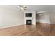 Spacious living room featuring a cozy fireplace, ceiling fan and wood-look floors at 420 Copeland St, Grayson, GA 30017