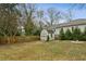 Landscaped backyard with storage shed, mature trees, and partial fence at 49 Wyman Se St, Atlanta, GA 30317