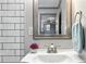 Bathroom with a white vanity, stainless steel faucet, and modern wall-mounted mirror at 49 Wyman Se St, Atlanta, GA 30317