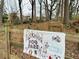 Kirkwood dog park sign on a wooden fence amidst natural surroundings, showcasing a welcoming space for pets and their owners at 49 Wyman Se St, Atlanta, GA 30317